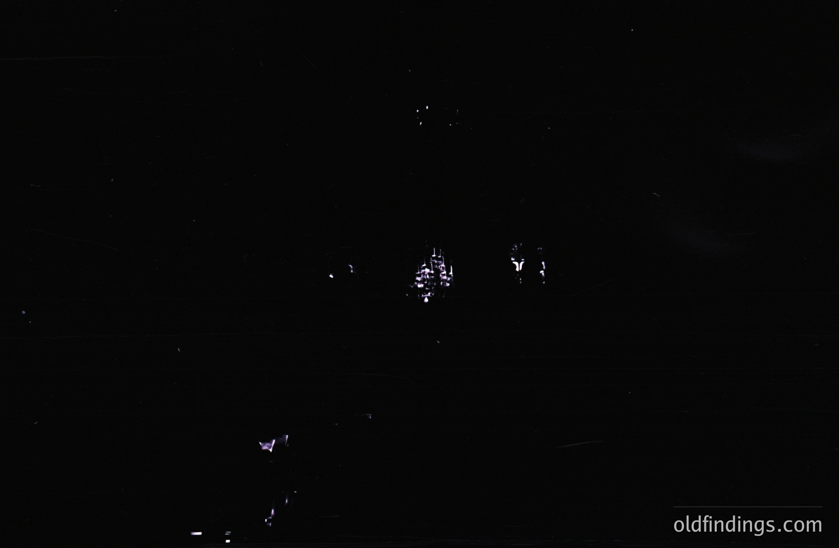 A nighttime architectural view displays a building with lit windows, seemingly a structure with multiple stories. The surrounding environment is enveloped in darkness, emphasizing the illuminated facade. Potential stock photo use for design or architectural projects.