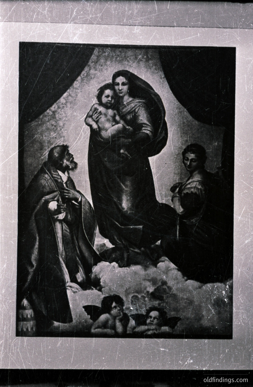 Seated Virgin Mary cradling a child, flanked by a bearded man and a woman, with cherubic figures floating nearby on clouds. Likely a religious icon or mural fragment, black and white photography. Artistic style reminiscent of Baroque or Renaissance influences. Potential for historical/religious research.