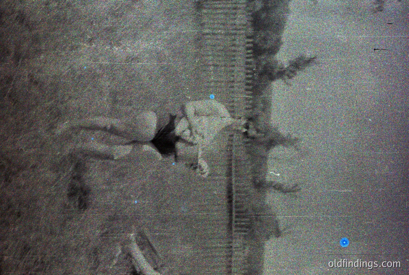 A grainy black-and-white image shows a person in a sharp suit holding a briefcase, ascending an escalator. The escalator's moving stairs create strong diagonal lines. Likely a business traveler, suggestive of post-war economic growth or urban development. The overall composition hints at a mid-century transit hub.