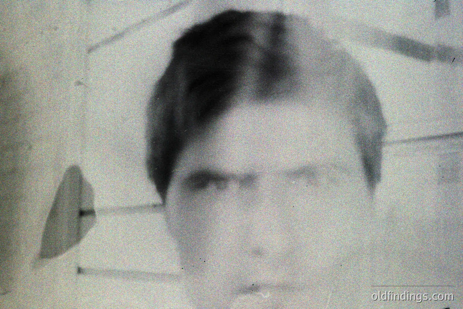 A vintage portrait of a man with short, neatly styled hair and a serious expression. Grainy black and white image, likely a photographic print from the mid-20th century. Subject’s clothing is simple, suggesting a casual or formal setting. Appears to be studio portrait.