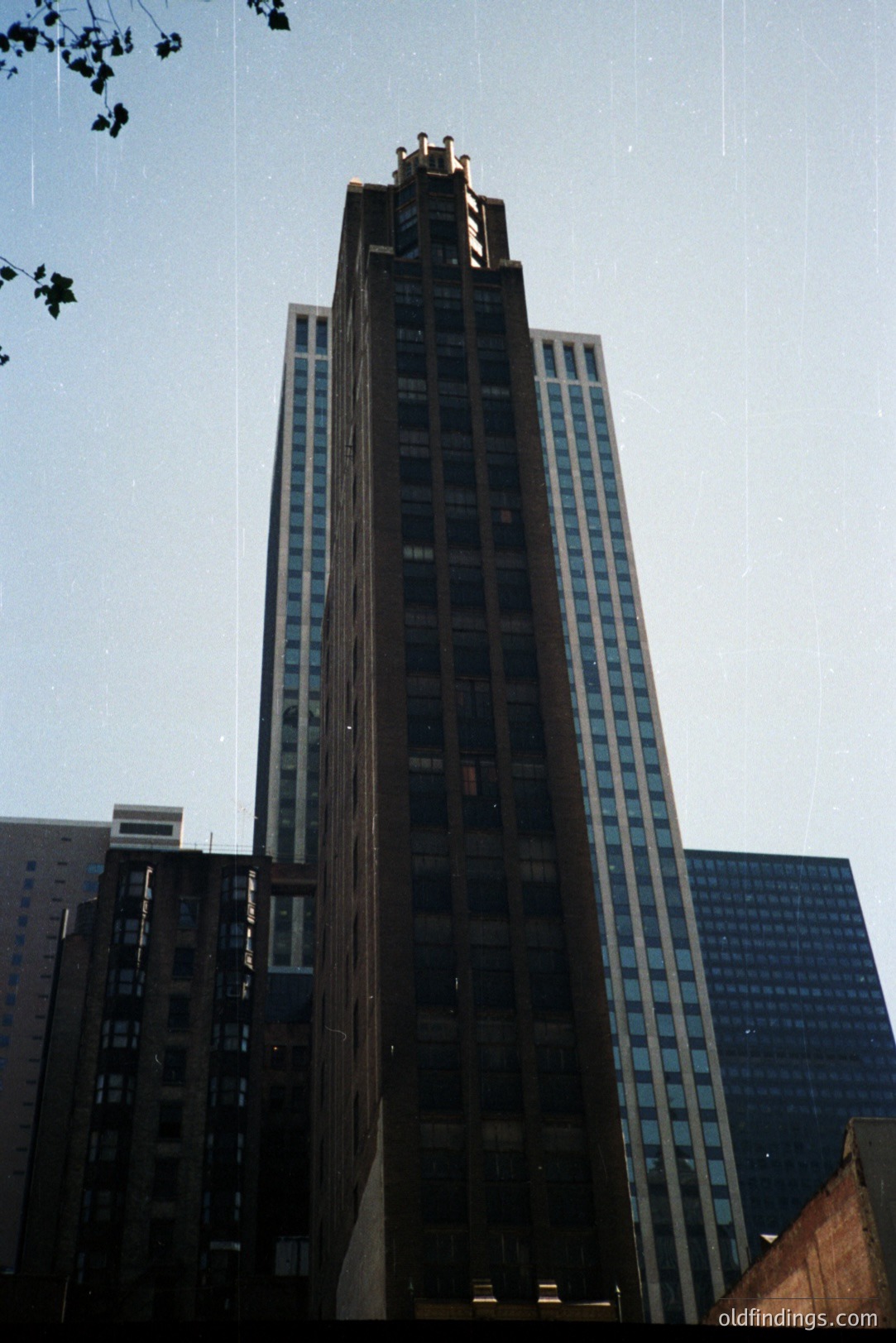 Looking up at the iconic Chicago Board of Trade Building, a masterpiece of early skyscraper architecture. Detailed cornices and gothic-inspired ornamentation define its upper levels. Constructed 1930-1938. A strong example of Art Deco design.