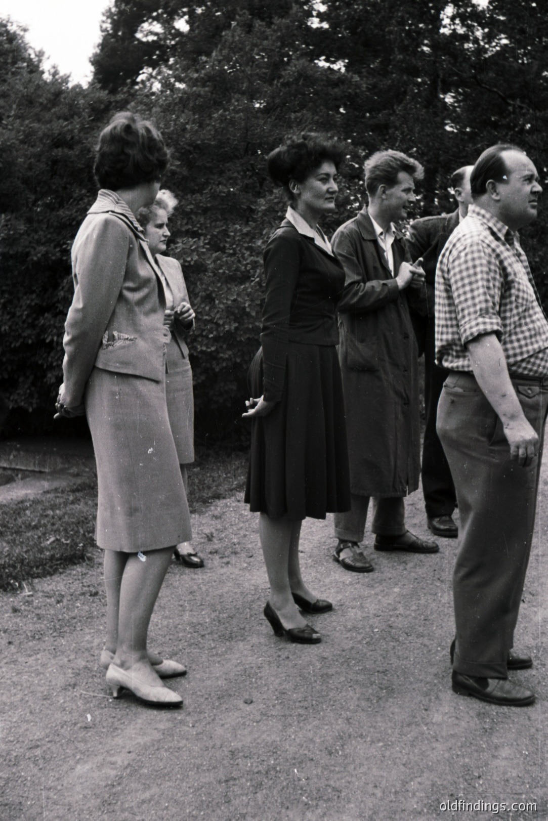 Group portrait of five people in a garden setting. Women wear 1960s-era tailored suits and dresses; men wear coats and plaid shirts. Appears to be an official or staged photograph - possibly a diplomatic visit or cultural exchange. Neutral background; limited contextual information.