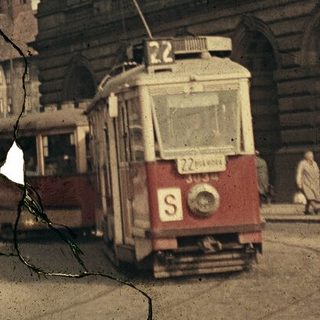 Vintage city scene with damaged tram and downed wires.