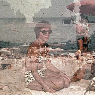 Vintage beach scene with people relaxing and sunbathing.