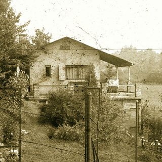 Vintage rural house on elevated wooden platform.