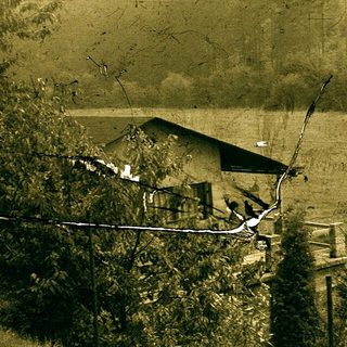 Rural house partially damaged by flood or landslide.