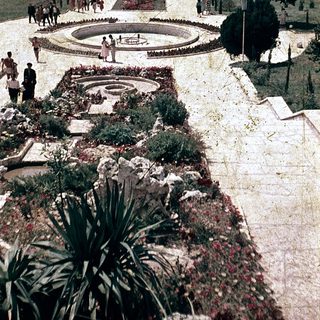 Vintage seaside park with formal gardens and fountain.