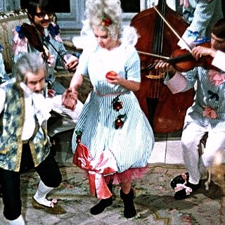 People dancing and playing classical music indoors.