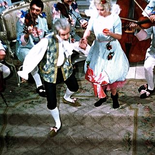 People dancing and playing classical music indoors.