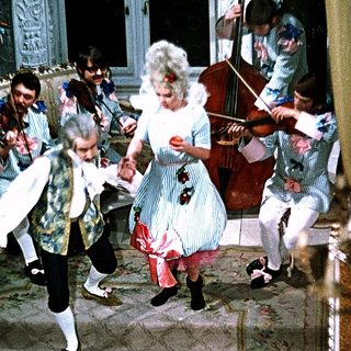 People dancing and playing classical music indoors.