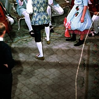 Ballroom dance performance with vintage costumes.