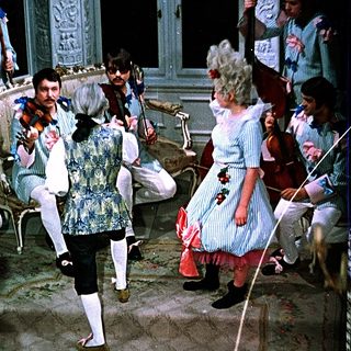 Ballroom dance performance with vintage costumes.