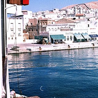 Coastal town harbor with waterfront buildings.