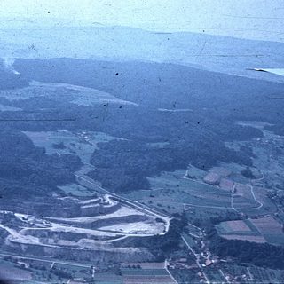 Aerial view of rural landscape with fields and winding roads.