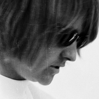 Young woman with short hair and sunglasses.