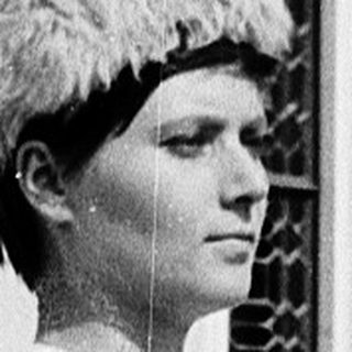 Woman in vintage striped robe and fur hat.