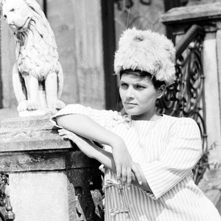 Woman in vintage costume posing with lion statue.