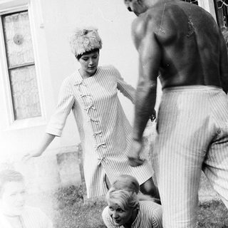 Family playing outdoors in casual summer attire.