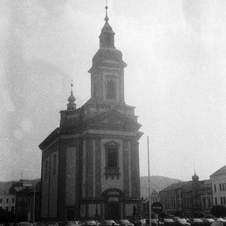 Neoclassical church with central bell tower.