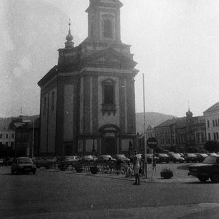 Neoclassical church with central bell tower.