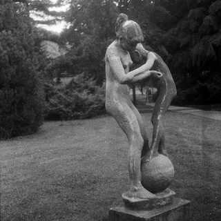 Erotic bronze sculpture of couple embracing.