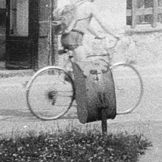 Vintage street scene with old building and bicycle.