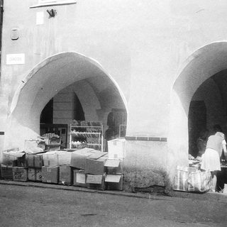 Vintage street market stall with arched entrance.