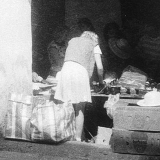 Vintage street market stall with arched entrance.