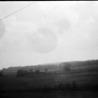 Rural landscape with misty horizon and open fields.
