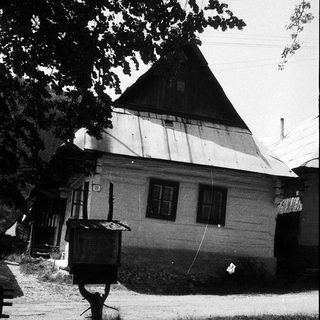 Traditional wooden house with steep gable roof.