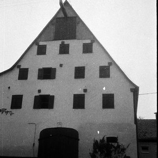 Traditional half-timbered farmhouse with steep gabled roof.
