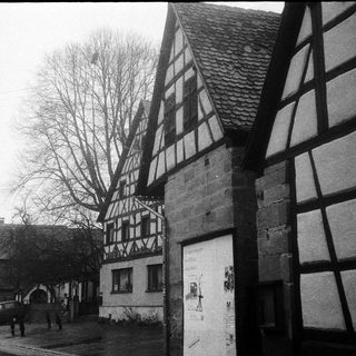 Traditional half-timbered houses in a quiet village street.