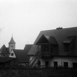 Rural buildings with church steeple and residential homes.