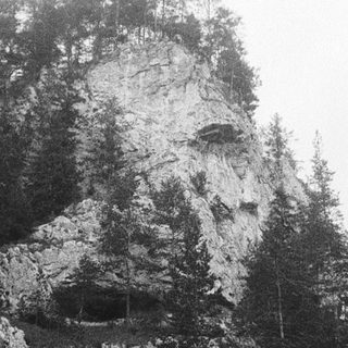 Misty mountain peak with rocky cliffs.