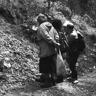 People examining large rock formations outdoors.