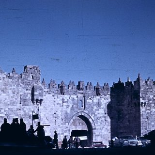 Historic stone city gate with battlements.