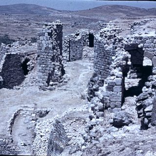Ancient stone ruins in arid landscape.