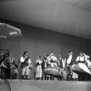 Traditional folk group performing on stage.