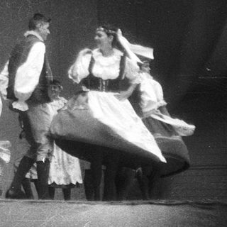 Traditional folk group performing on stage.