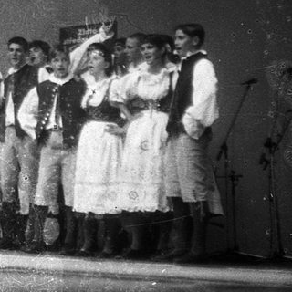 Traditional folk band performing outdoors in traditional attire.