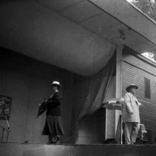 Vintage outdoor performance with pianist and singer.
