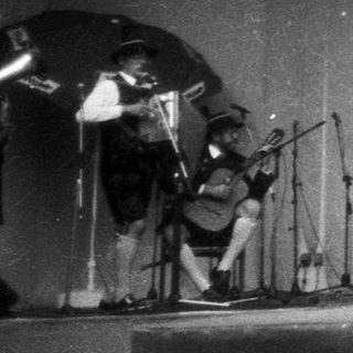 Traditional folk dance performance on stage.