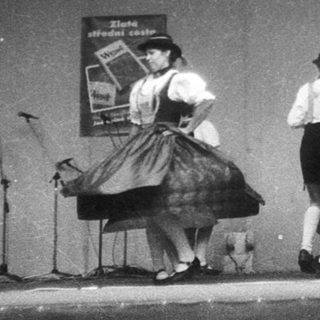 Traditional folk dance performance on stage.