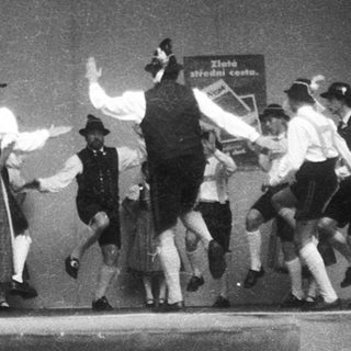 Traditional folk dance performance on stage.