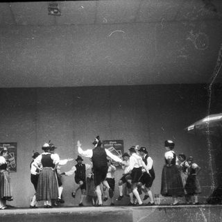 Traditional folk dance performance on stage.