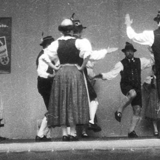 Traditional folk dance performance on stage.