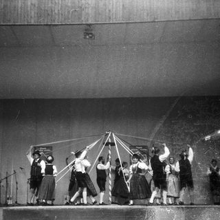 Group performing traditional rope dance on stage.