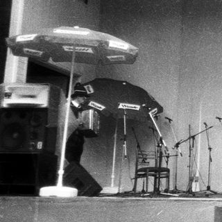 Band performing on stage with microphones.