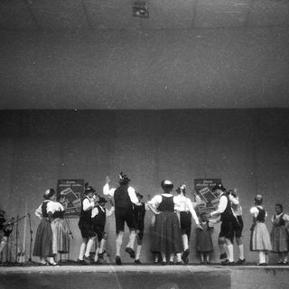 Traditional folk dancers performing on stage.