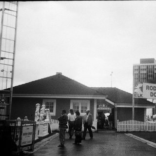 Train station entrance with "Rodinné Domy ELK" housing signage.